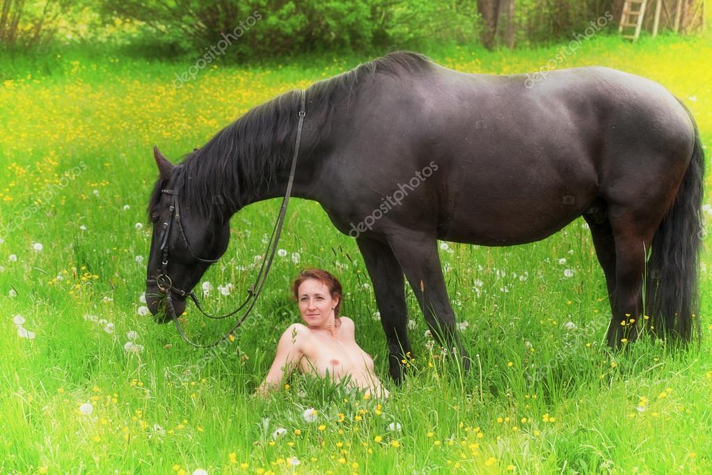 Молодая обнаженная женщина с лошадью наслаждается сельским воздухом 